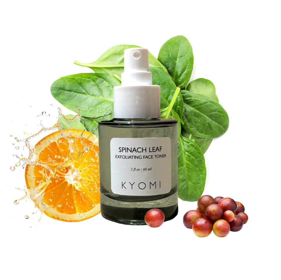 KYOMI spinach leaf exfoliating face toner bottle with spinach leaves, an orange, and grapes on a white background