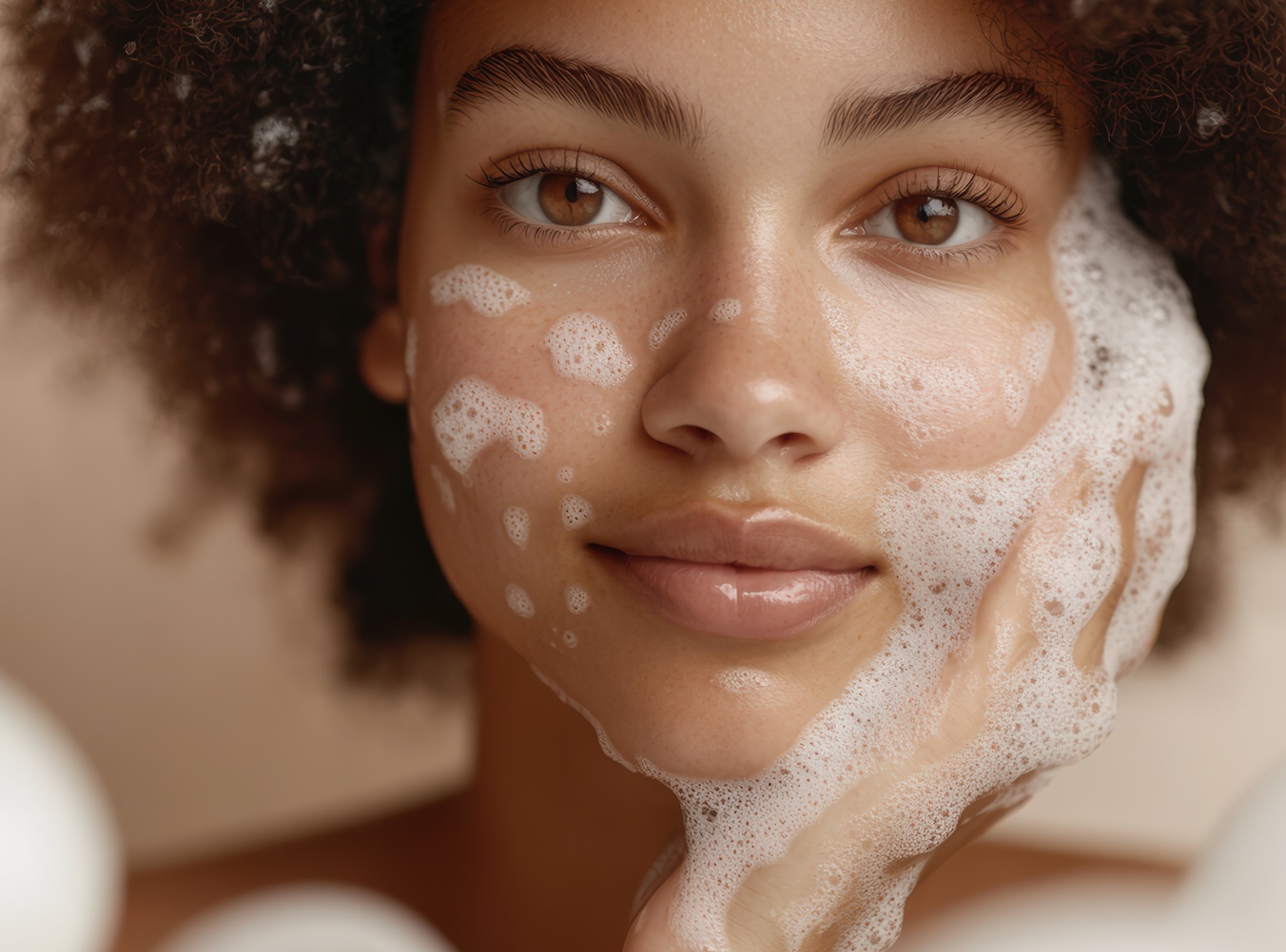 “Woman gently cleansing her face with a botanical cleanser as part of an anti-aging skincare routine, demonstrating dermatologist-recommended cleansing techniques for healthy, youthful skin.”