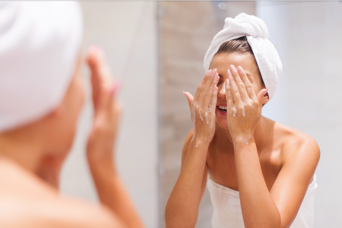 Woman washing her face. Best natural face wash products