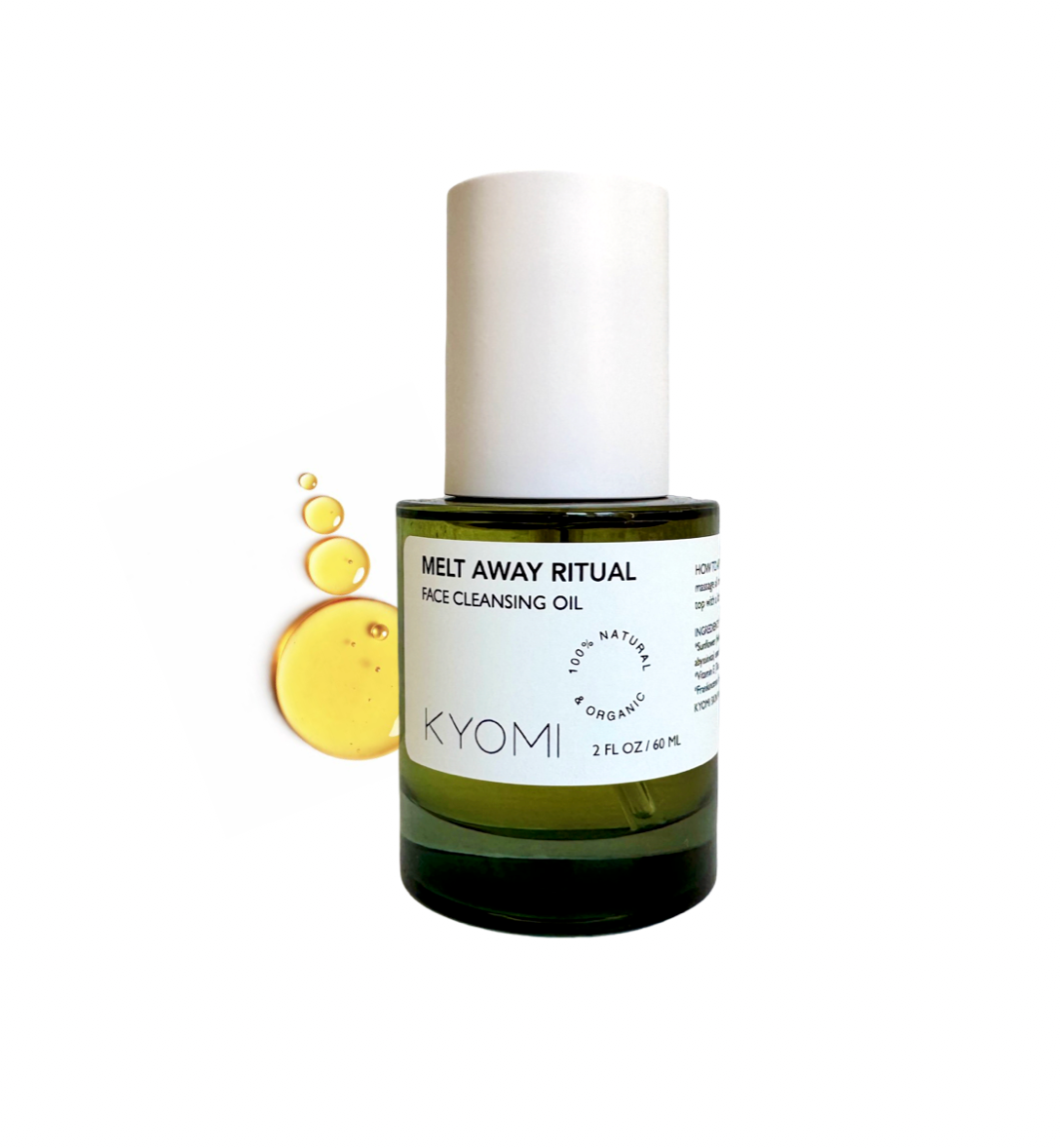 Bottle of KYOMI face cleansing oil with droplets on a white background