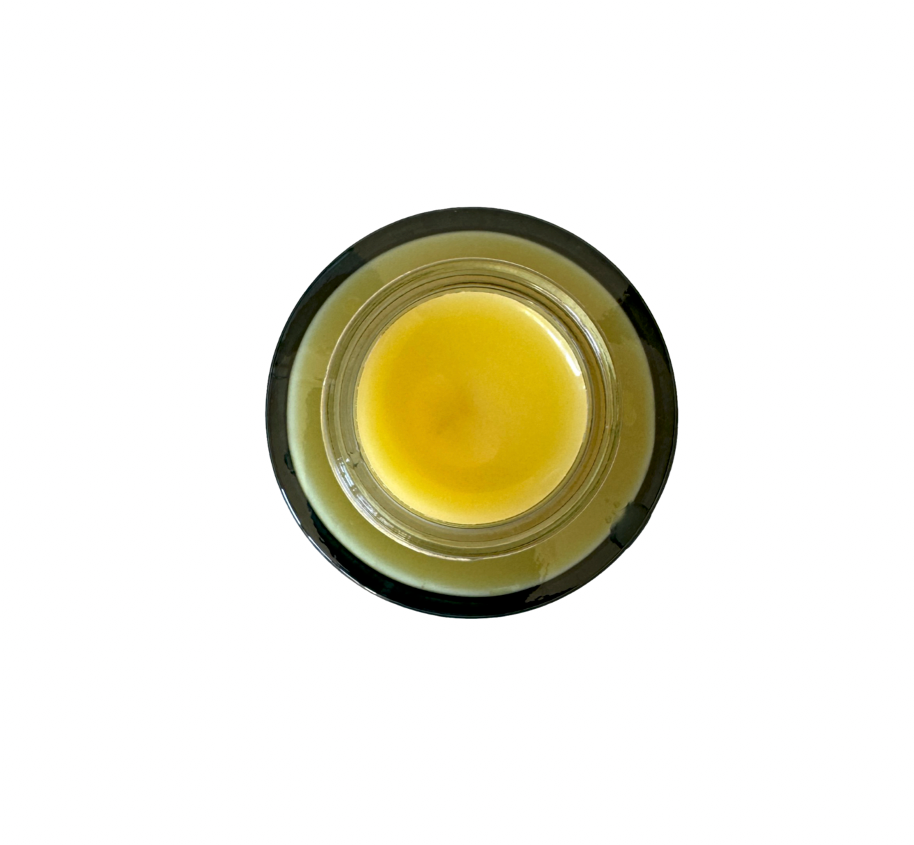 Small jar of yellow cream on a white background