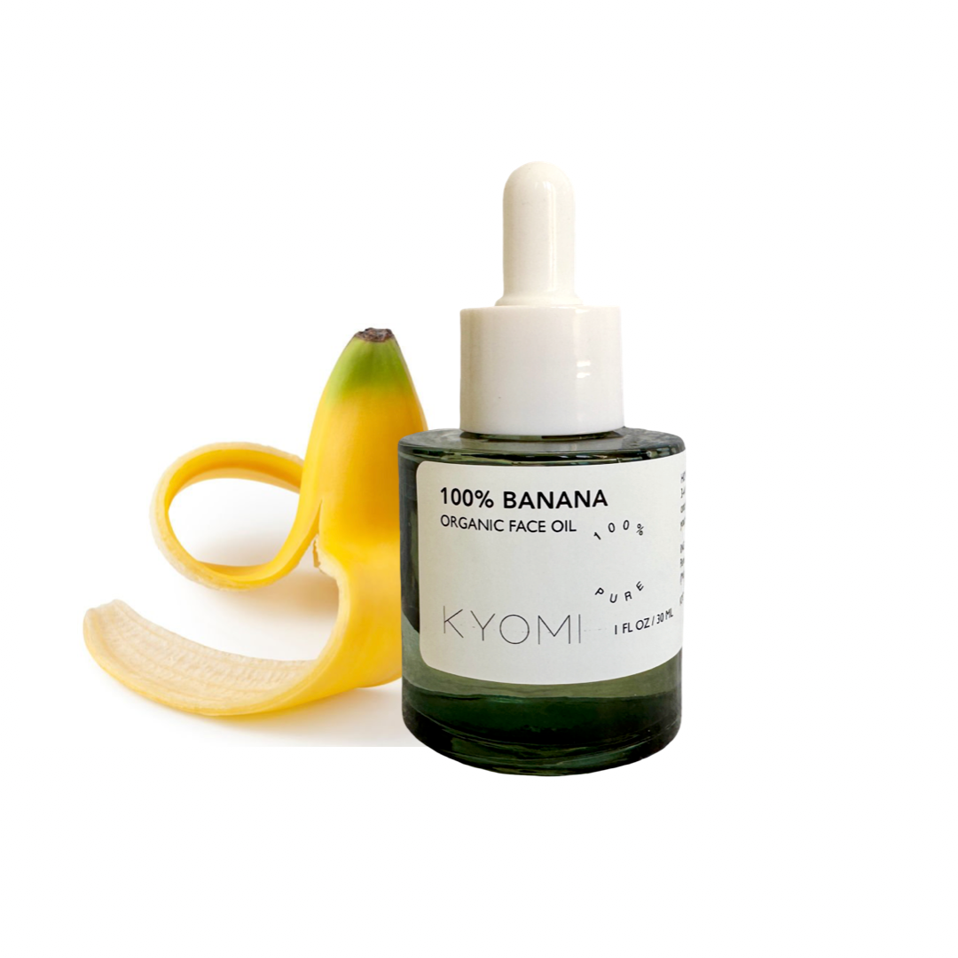 Bottle of KYOMI 100% Banana Organic Face Oil with a banana on a white background
