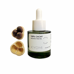 Bottle of KYOMI 100% Cacay Organic Face Oil with wooden applicators on a white background