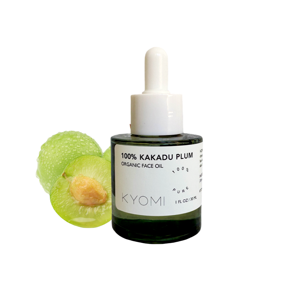Bottle of KYOMI 100% Kakadu Plum Organic Face Oil with a green fruit on a white background