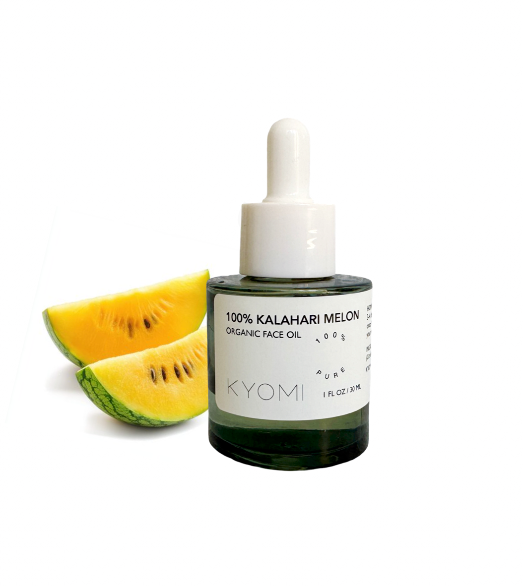 Bottle of KYOMI 100% Kalahari Melon organic face oil with two slices of melon on a white background